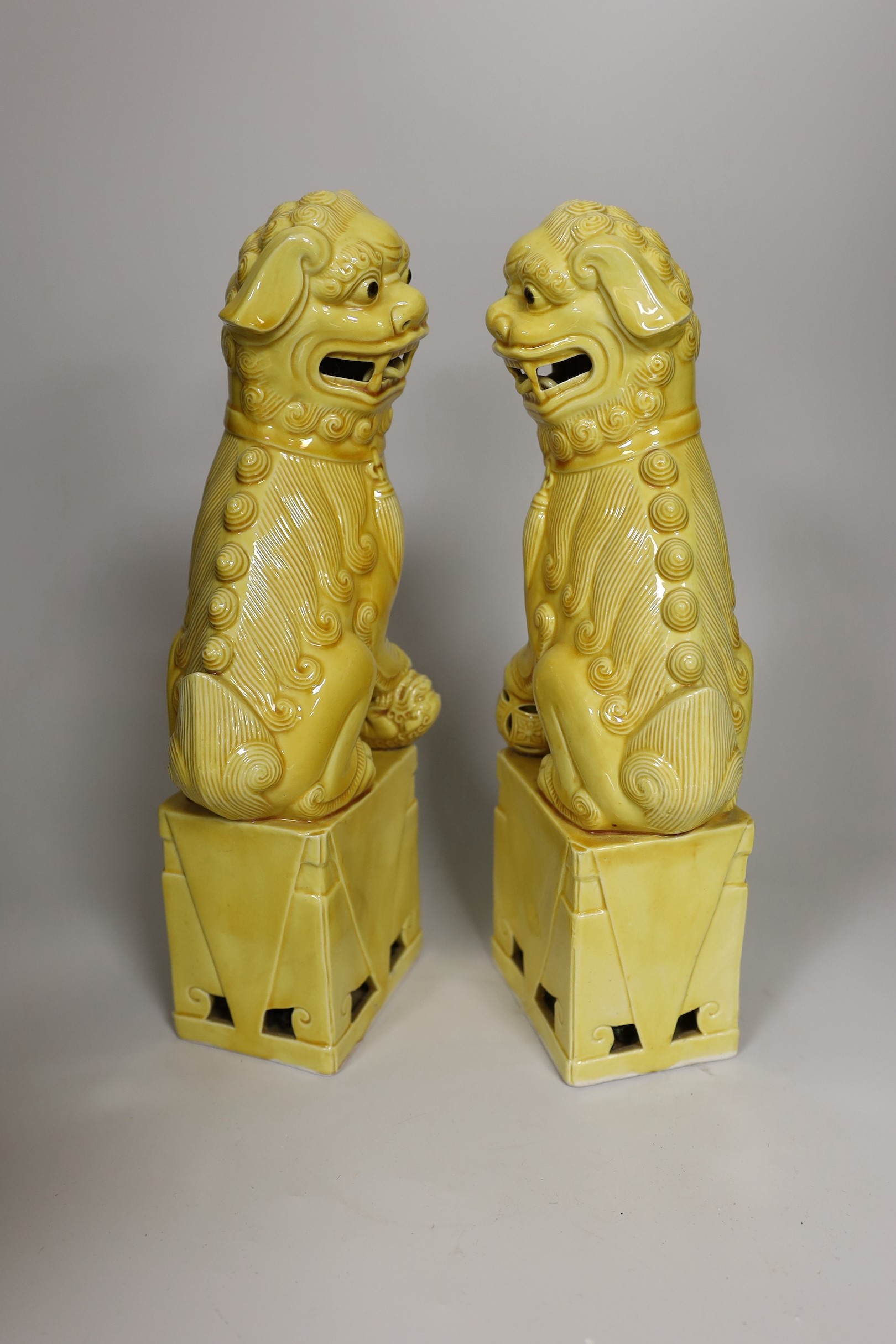 A pair of Chinese yellow glazed temple lion dogs 30cm